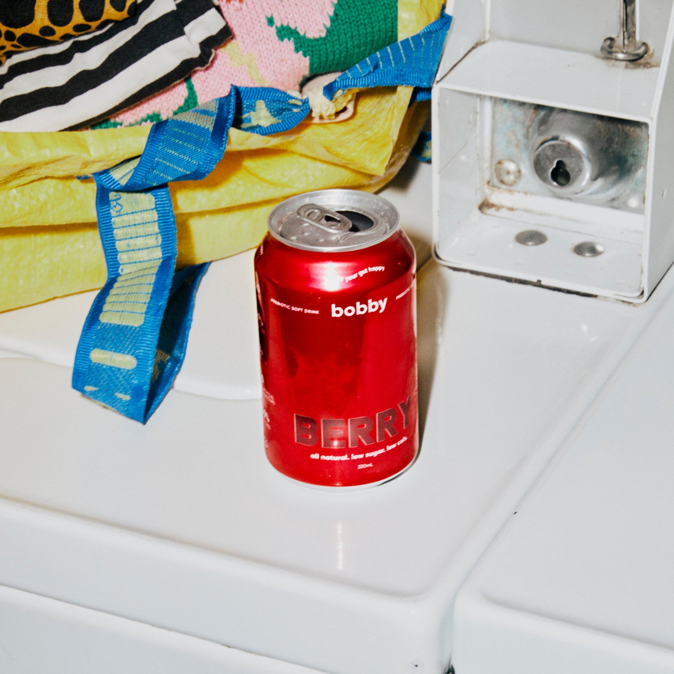  our radiant bobby berry soda photographed in an unconventional laundry mat